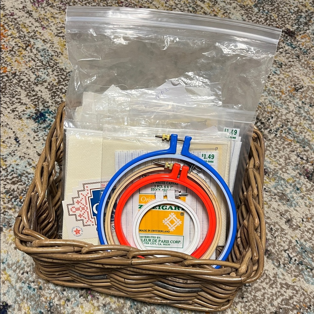 Embroidery Hoops and cross stitch fabric in wooden basket